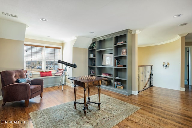 sitting room with crown molding and hardwood / wood-style floors