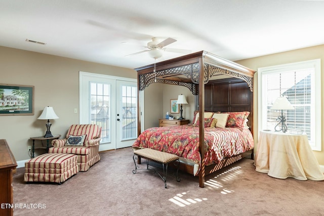 bedroom with french doors, carpet flooring, multiple windows, and access to outside