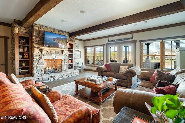 living room featuring hardwood / wood-style flooring, a fireplace, and beam ceiling