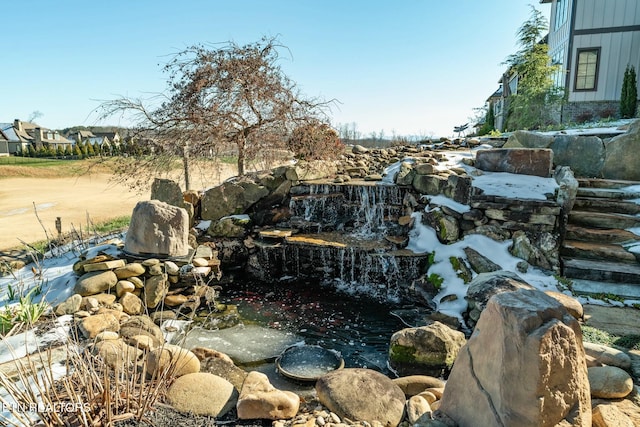 view of yard with a garden pond