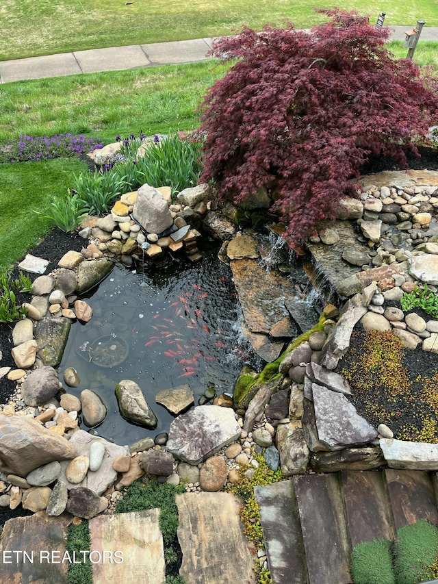 exterior details featuring a garden pond