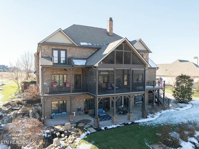 back of house with a patio area, french doors, and a balcony