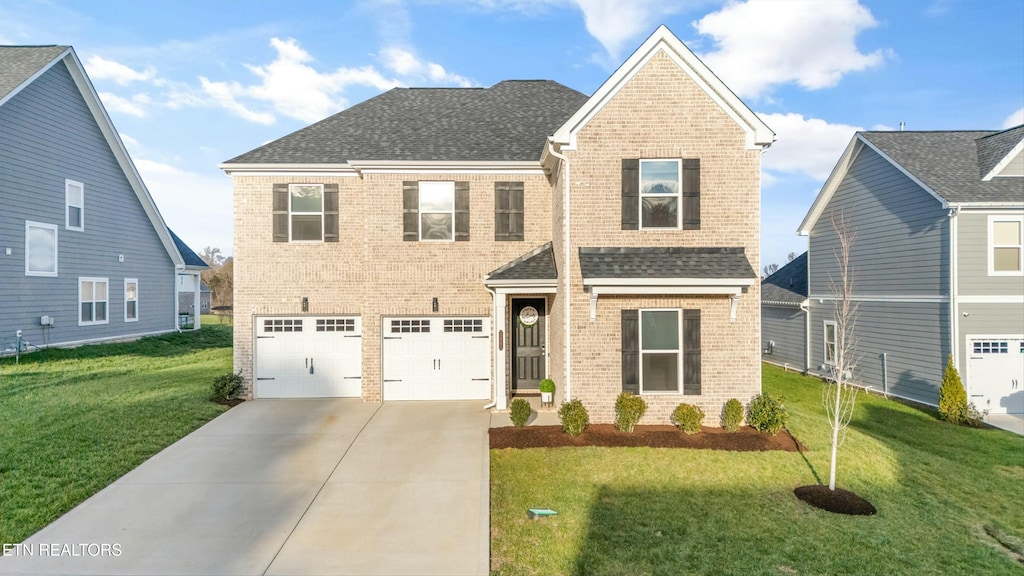 view of front of house featuring a garage and a front lawn