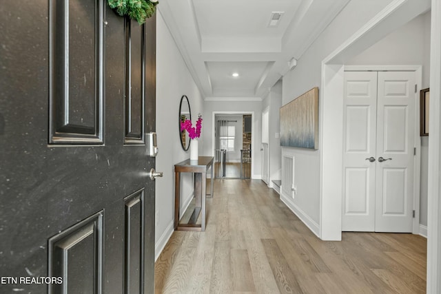 foyer entrance featuring light hardwood / wood-style floors and crown molding