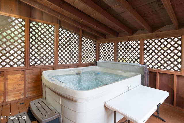 wooden terrace with a hot tub