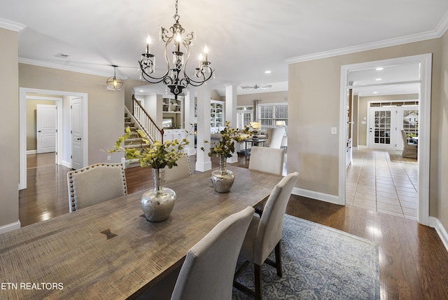 dining space with ornate columns, crown molding, a healthy amount of sunlight, and dark hardwood / wood-style floors