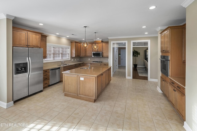 kitchen with sink, crown molding, an island with sink, pendant lighting, and appliances with stainless steel finishes