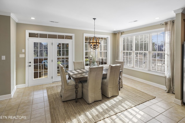 tiled dining room featuring ornamental molding and a chandelier