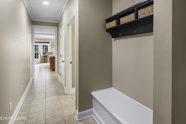 mudroom featuring light tile patterned flooring and ornamental molding