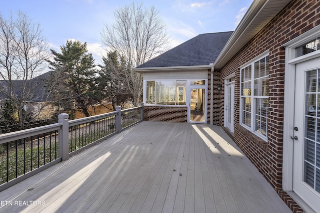 wooden terrace featuring a sunroom