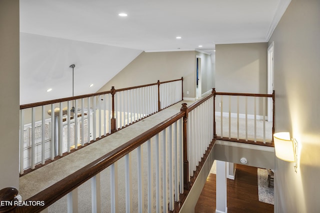 hall with crown molding, dark wood-type flooring, and vaulted ceiling