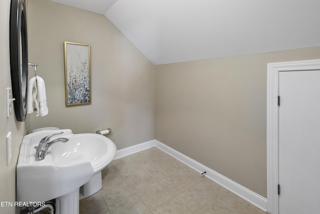 bathroom with sink and vaulted ceiling