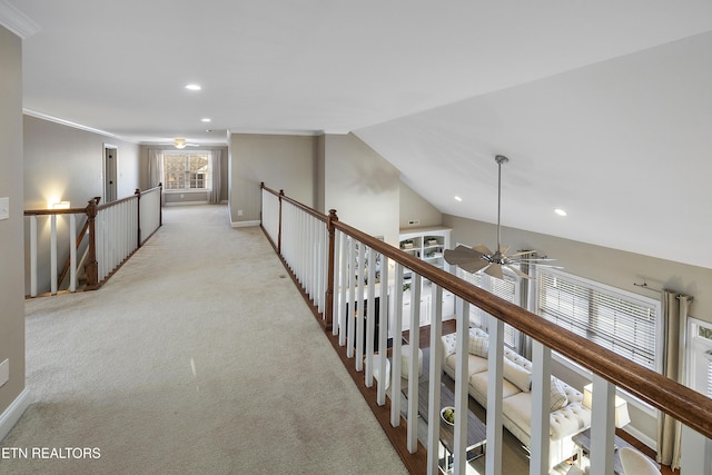 hallway featuring light colored carpet and vaulted ceiling