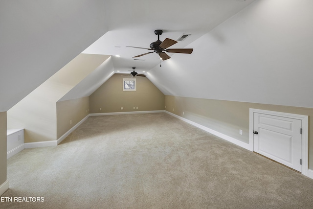 bonus room with ceiling fan, light carpet, and vaulted ceiling