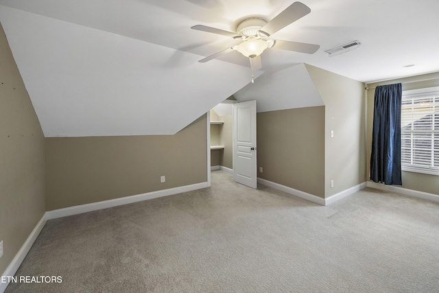 bonus room with ceiling fan, lofted ceiling, and light carpet