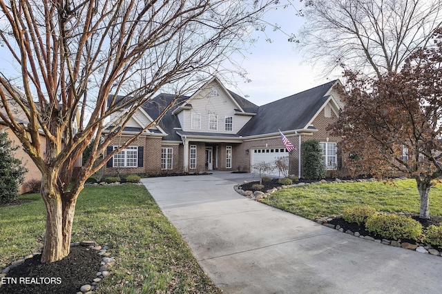 view of front of home with a garage and a front lawn