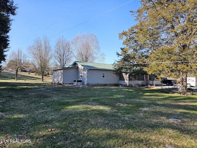 view of home's exterior with a yard