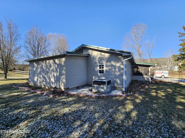 view of property exterior with a yard