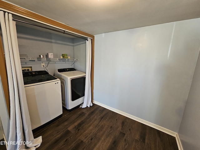 clothes washing area featuring washer and dryer and dark wood-type flooring