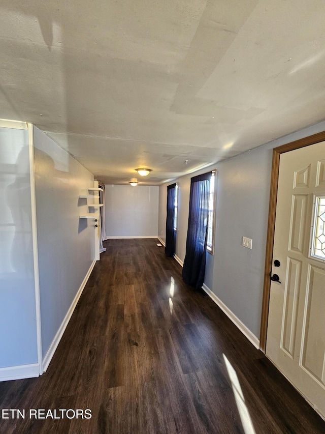 hall with dark wood-type flooring