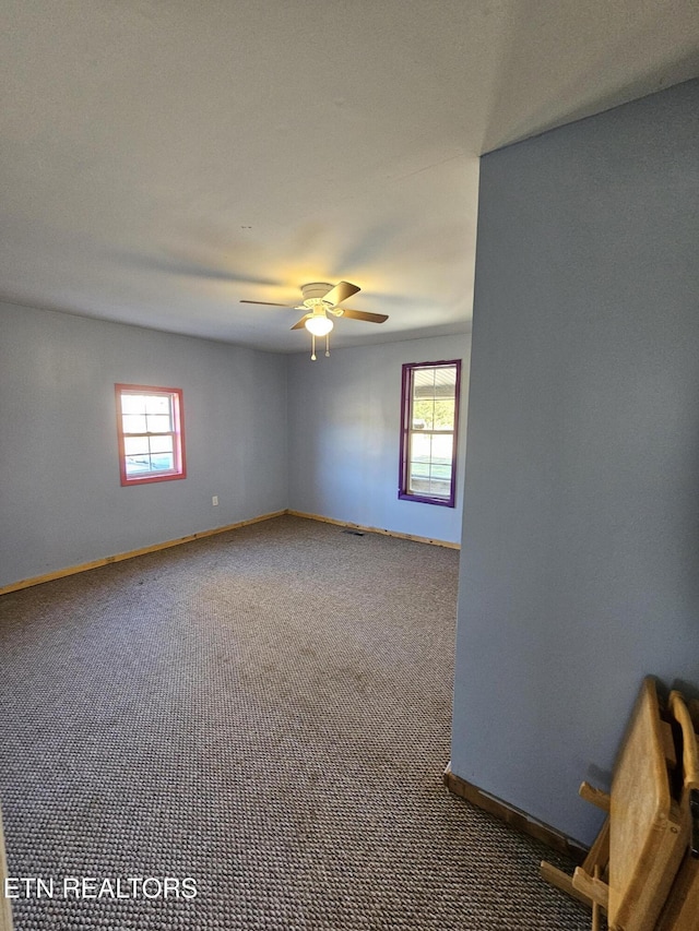 carpeted empty room featuring ceiling fan