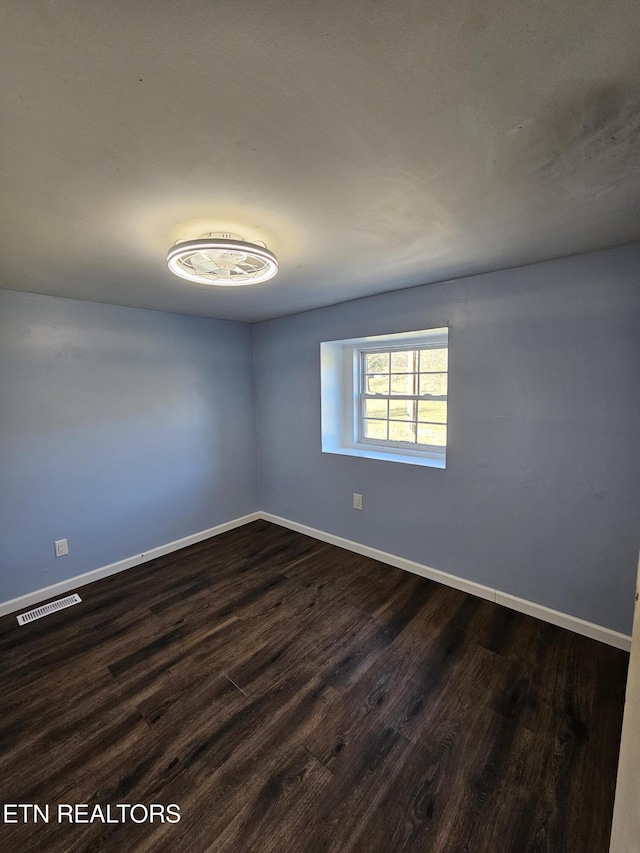 unfurnished room featuring dark hardwood / wood-style floors