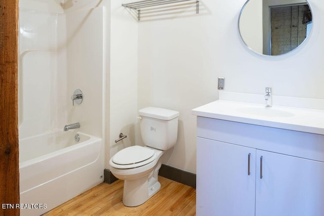 full bathroom featuring hardwood / wood-style floors, vanity, shower / bathtub combination, and toilet