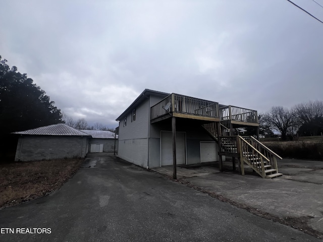 back of property featuring a wooden deck