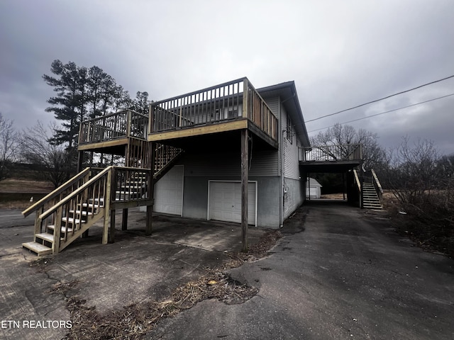 view of home's exterior with a garage and a wooden deck