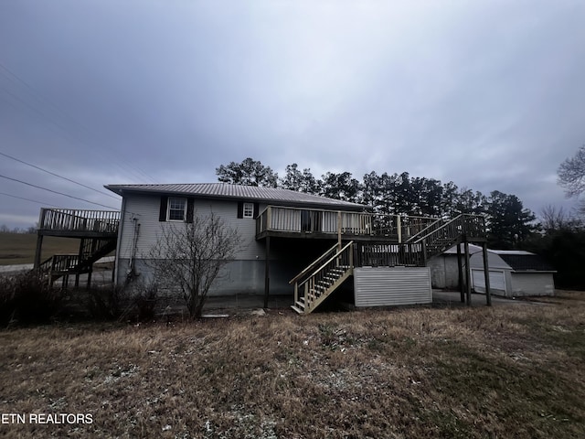 view of front of house with a deck and an outdoor structure