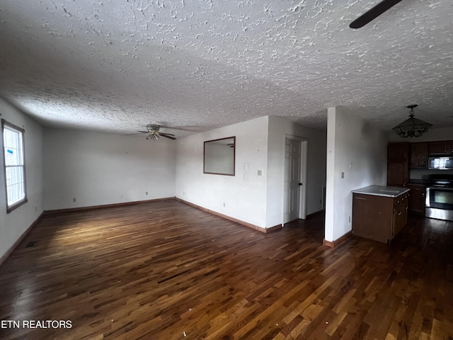 unfurnished living room featuring a textured ceiling, dark hardwood / wood-style floors, and ceiling fan