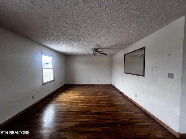 spare room featuring ceiling fan, dark hardwood / wood-style flooring, and a textured ceiling