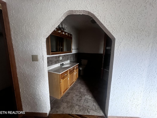 kitchen featuring sink and dark tile patterned flooring