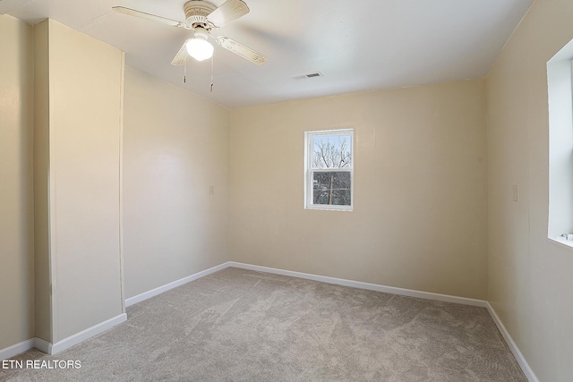 carpeted spare room with ceiling fan