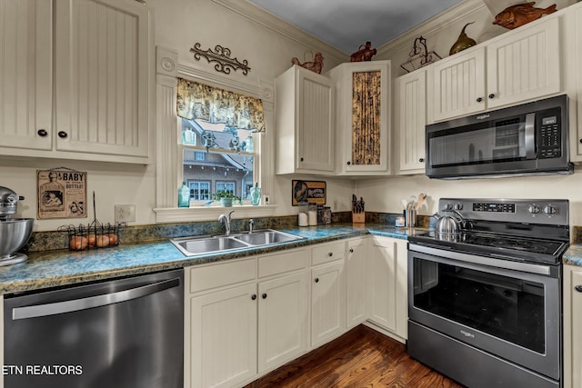 kitchen featuring dark hardwood / wood-style floors, white cabinetry, sink, stainless steel appliances, and crown molding