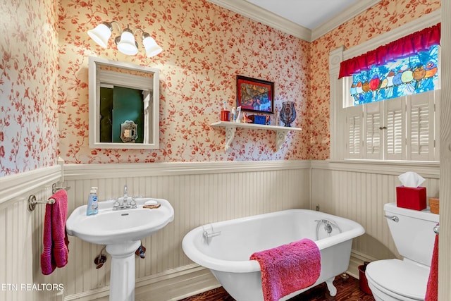 bathroom with wood-type flooring, a tub, ornamental molding, and toilet