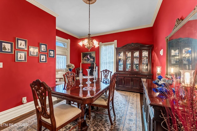 dining area with crown molding, a chandelier, and hardwood / wood-style floors