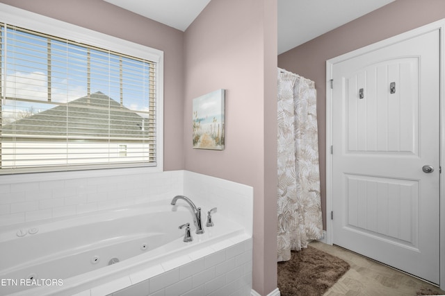 bathroom featuring tiled tub