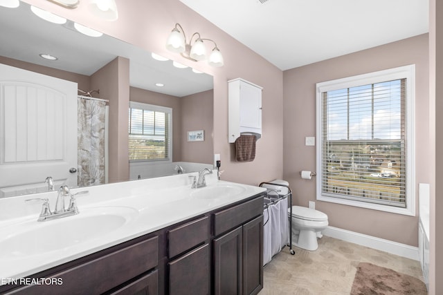 bathroom with vanity, toilet, and walk in shower