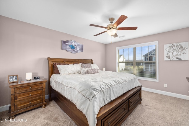 bedroom with ceiling fan and light carpet