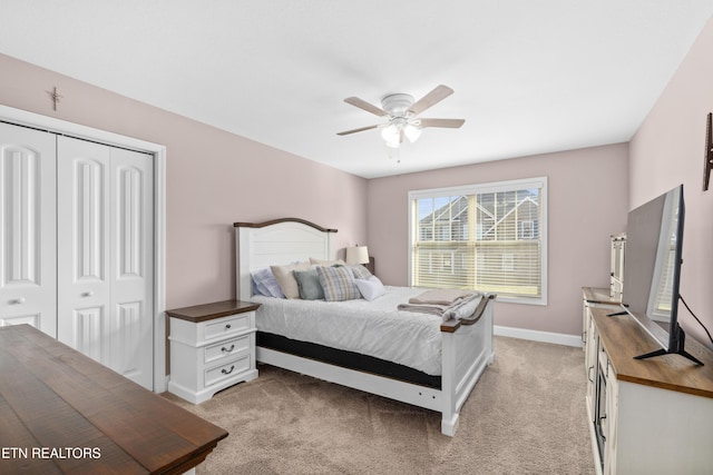 carpeted bedroom featuring ceiling fan and a closet