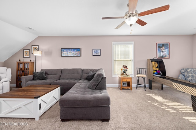 carpeted living room featuring ceiling fan and vaulted ceiling