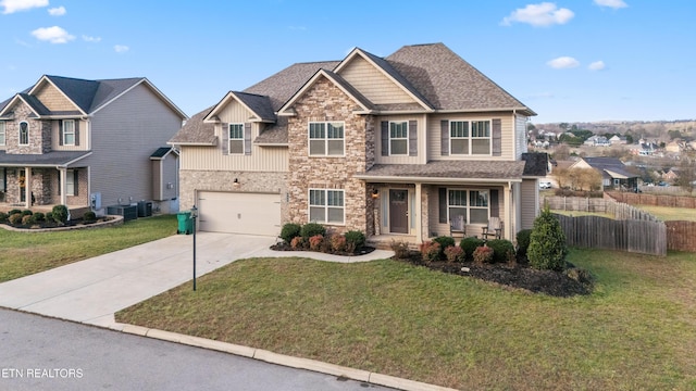 craftsman-style house with a front lawn, cooling unit, and a garage