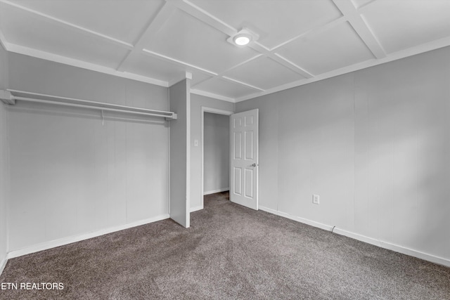 unfurnished bedroom featuring coffered ceiling, carpet floors, and a closet