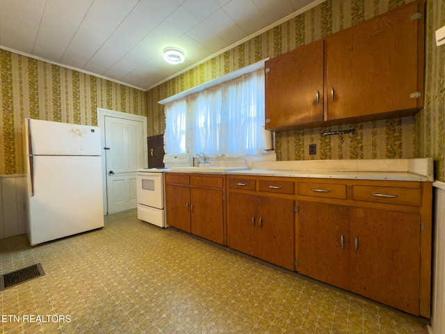 kitchen featuring white appliances, wallpapered walls, visible vents, light countertops, and light floors