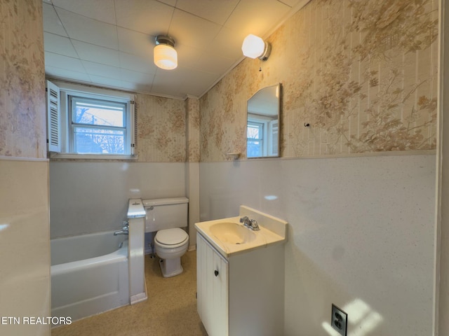 bathroom with a healthy amount of sunlight, wallpapered walls, a bathing tub, and vanity