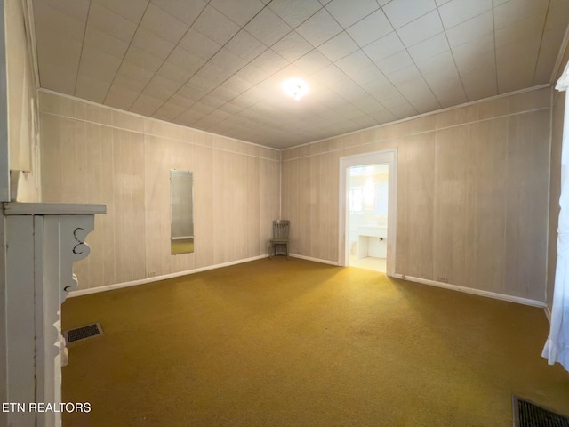 carpeted empty room with visible vents and baseboards