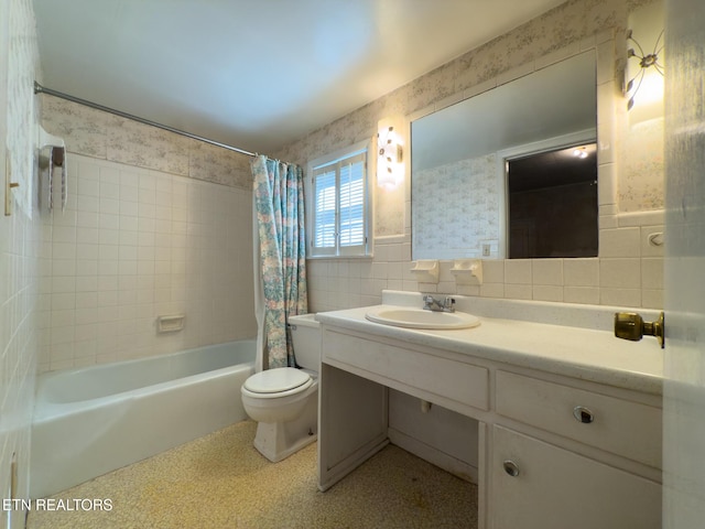 bathroom featuring tile walls, shower / bath combination with curtain, toilet, vanity, and wallpapered walls