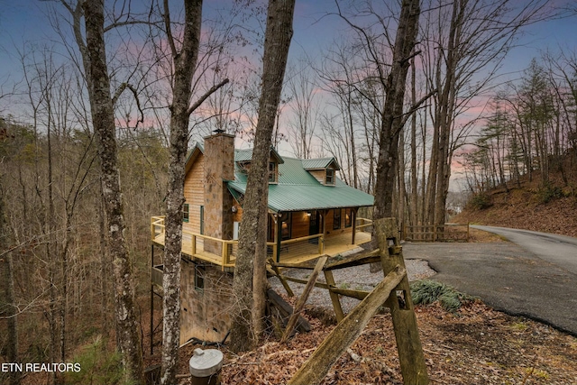 property exterior at dusk with covered porch