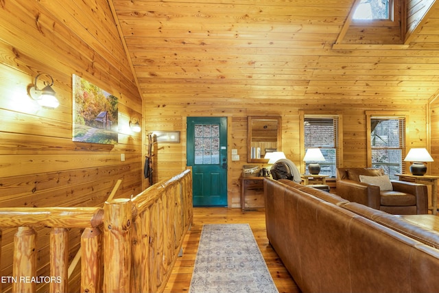 living room featuring wooden ceiling, light hardwood / wood-style flooring, wooden walls, and vaulted ceiling